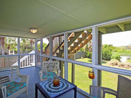 screened in porch on marsh grass witth kayaks